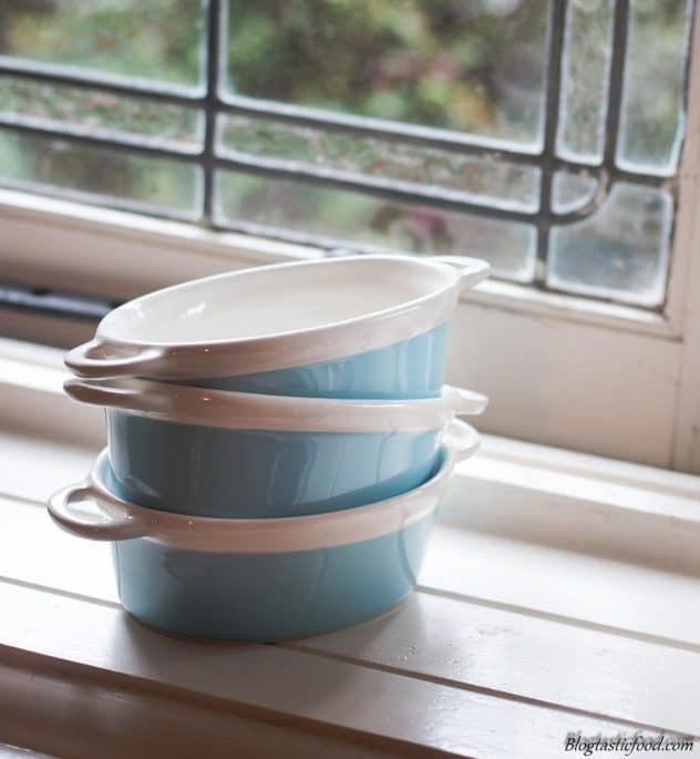 A photo of 3 mini baking dishes stacked up near a window.