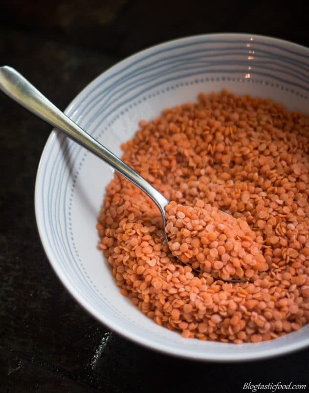 A picture of split red lentils in a bowl. 