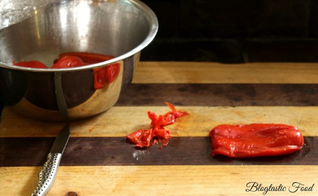 A photo showing how to remove the skin off of a roasted red pepper. 