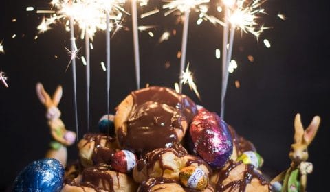 A bunch of sparkles lighting up over a mountain of profiteroles and Easter eggs.