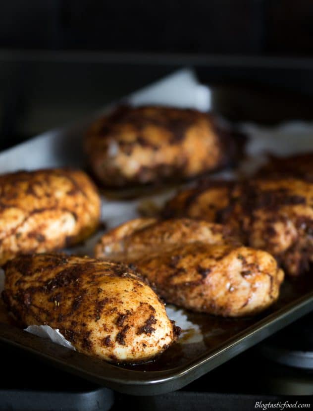 Cooked Cajun spiced chicken breasts that on a baking tray.
