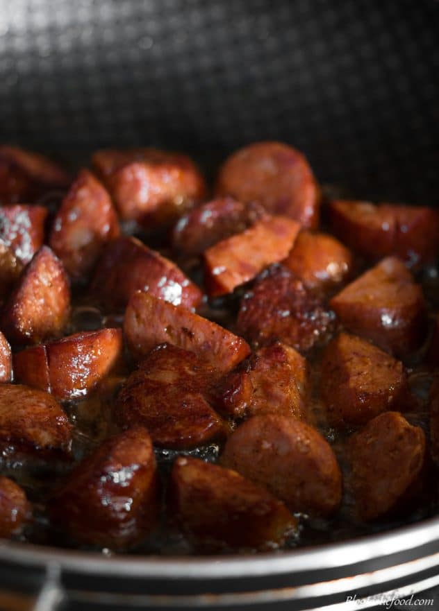 diced chorizo being fried in a hot pan. 