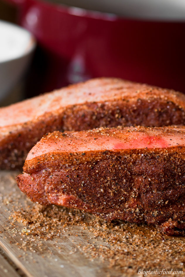 Raw pork shoulder that has been rubbed in a spice blend.