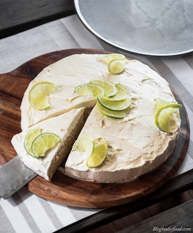 A slice being removed of a citrus buttercream coated cake. 