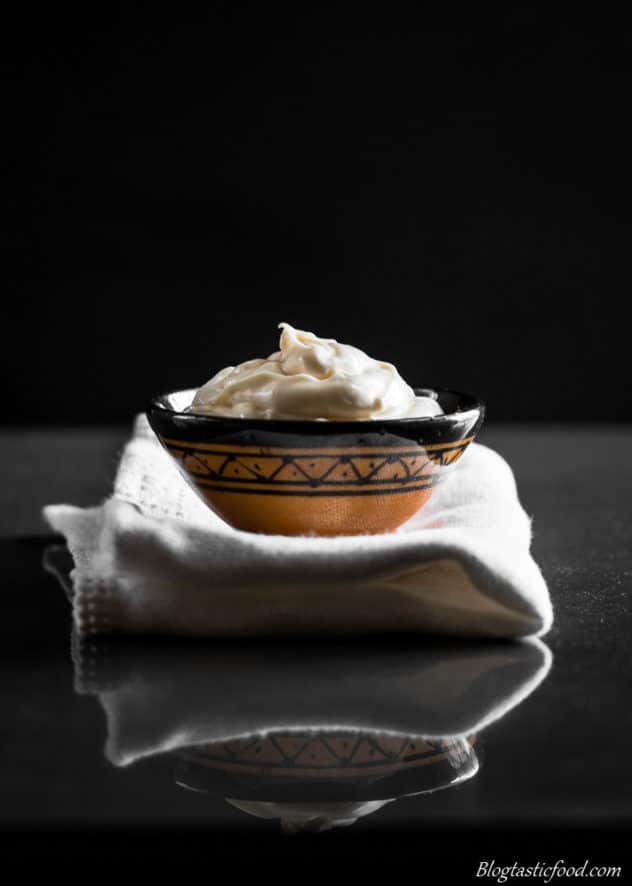 An eye level photo of aioli served in a mini bowl.