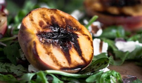 Beautiful, vibrant grilled nectarine and peach salad with rocket, spinach, goats cheese, red onion, balsamic glaze and pecans.