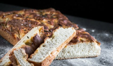 A focaccia bread recipe that is presented in the form of a pin for Pinterest.
