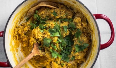 An over-head photo of red lentil dhal in a pot.