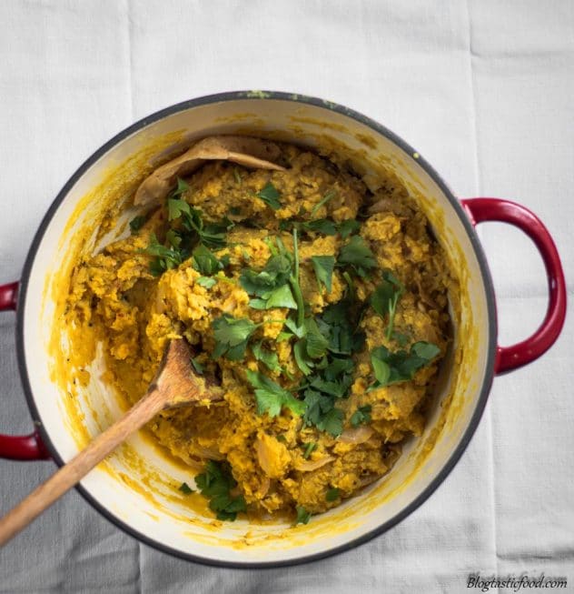 An over-head photo of red lentil dhal in a pot.