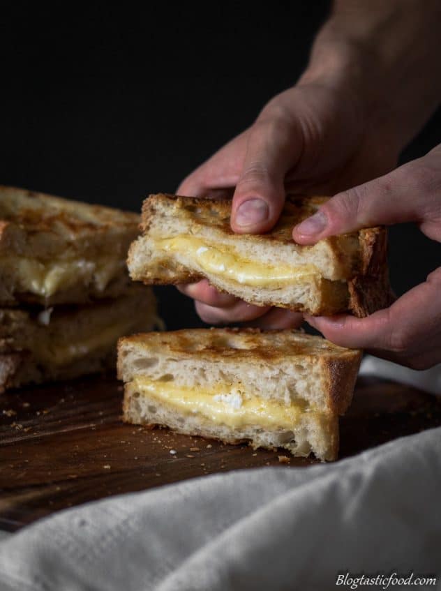 A photo of someone holing a grilled cheese sandwich.