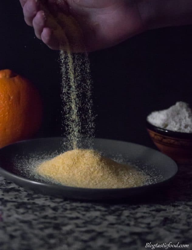 A photo of someone pouring polenta on a plate.