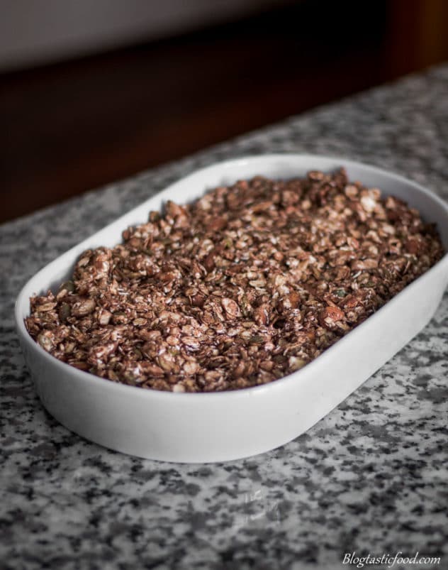 A photo of un-toasted granola in a baking tray.