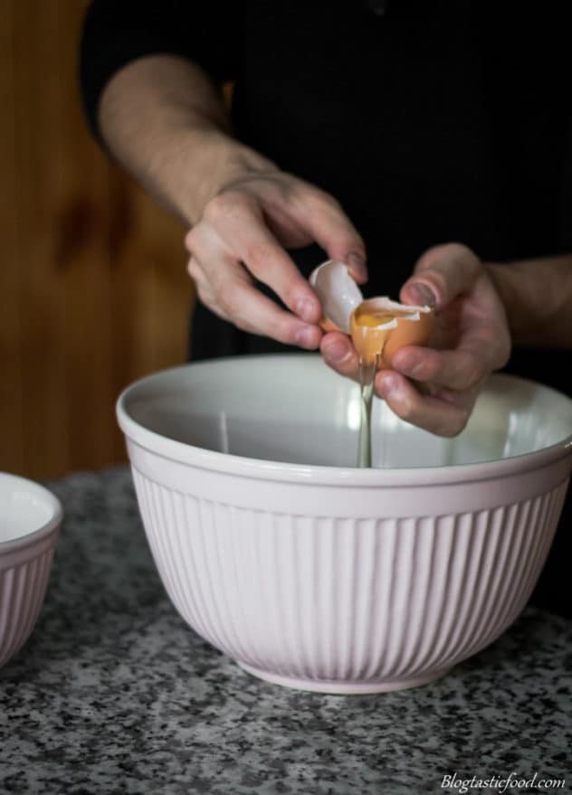 A photo of someone separating an egg.