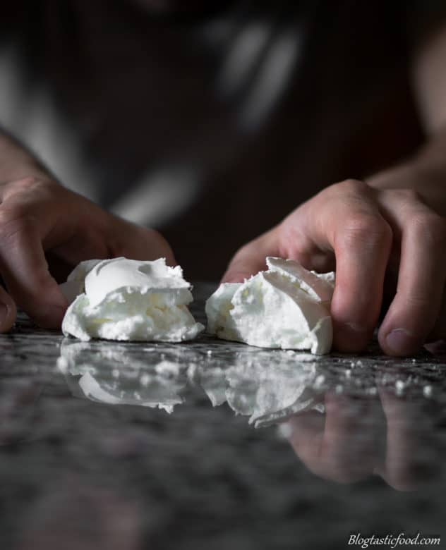 A photo of someone opening up a meringue.