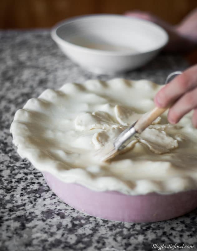 Egg washed being brushed over raw puff pastry.