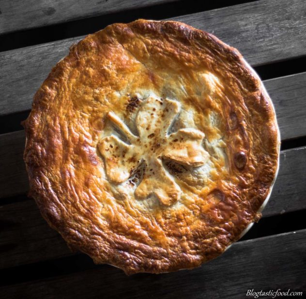 An overhead photo of an Irish stew pie with golden brown puff pastry on top.