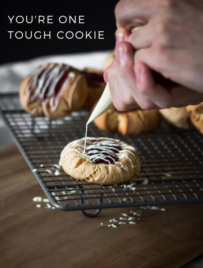 A front cover for a white chocolate drizzle peanut butter and jam cookie recipe with a pun written on it.