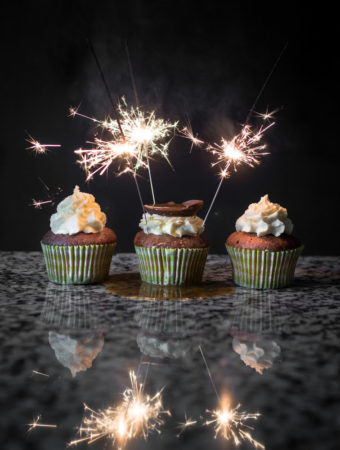 a photo of sparklers lighting up over a group of Easter cupcakes.