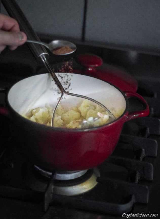 A photo of nutmeg being added to mashed potatoes.