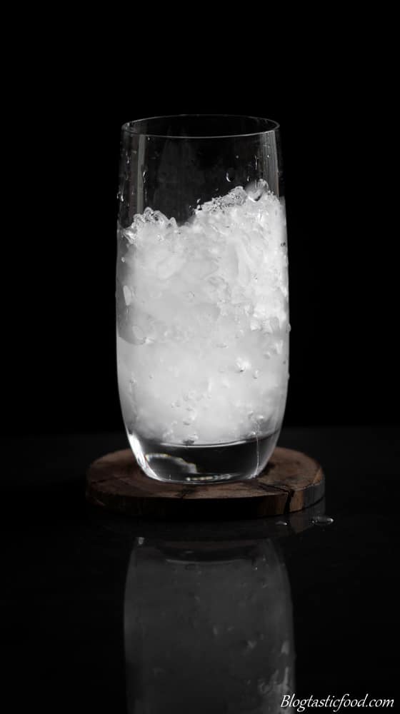 A cold glass that has been filled with ice. 