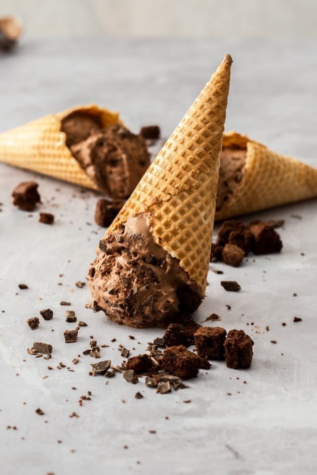 No churn chocolate brownie ice cream seved upside down in an ice cream cone.