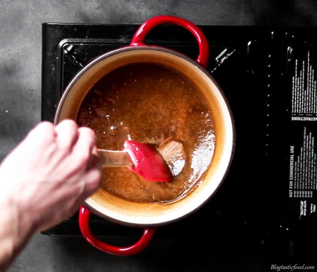 A photo of butterscotch sauce being stirred in a pan.