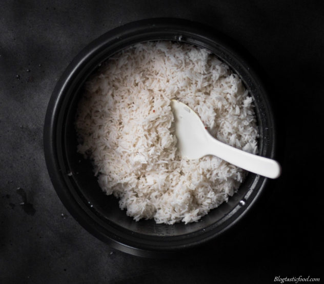 An overhead photo of cooked white rice in a pot. 