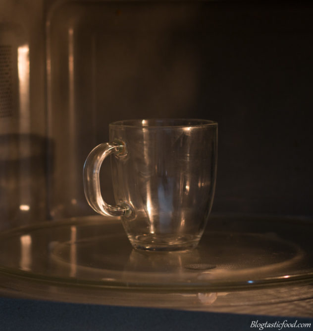 A glass mug in a microwave.