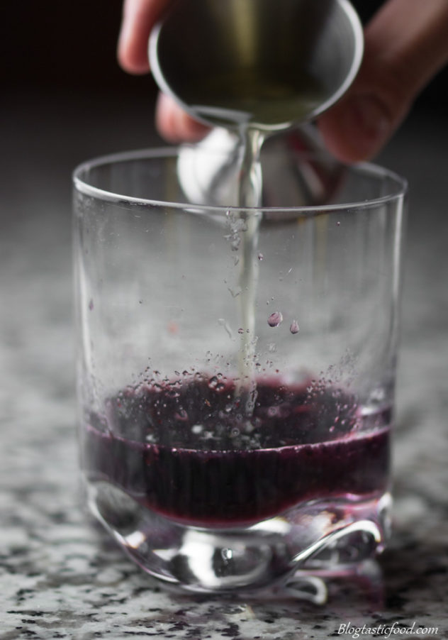 Infused water being added to muddles blackberries, sugar and vanilla. 