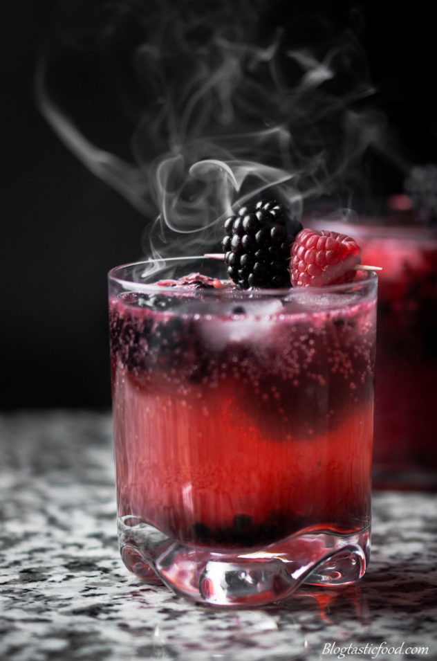 2 black widow cocktails with smoke floating around them. 