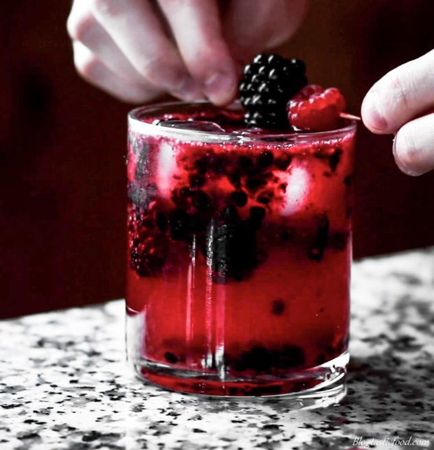 A Black Widow cocktail being garnished.