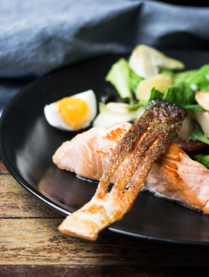 Crsipy salmon skin and pan fried salmon served with a nicoise salad.
