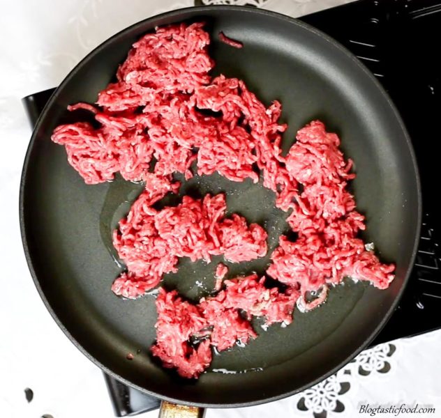 Beef mince frying in a non stick pan.