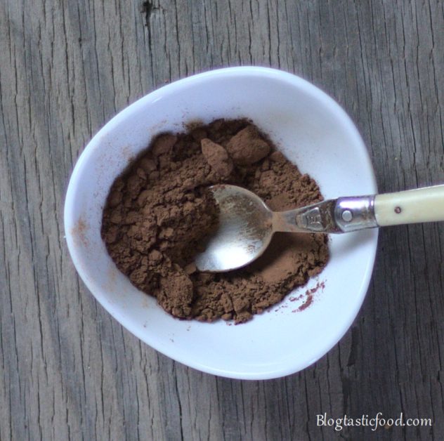 Cocoa powder and a small spoon in a mini bowl.