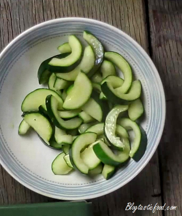 A photo of sliced and cooed courgettes in a bowl.