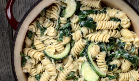 Creamy spinach and courgette pasta in a large pot ready to serve.