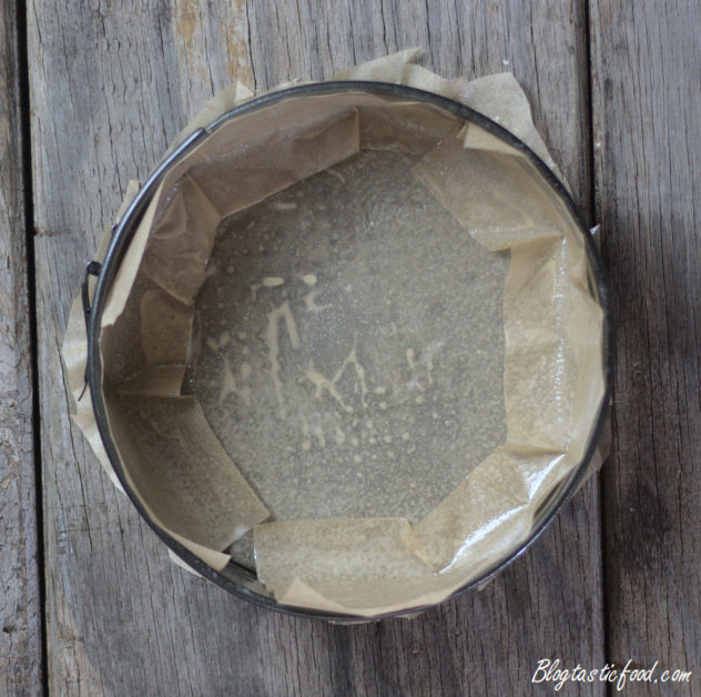 An overhead shot of a lined cake tin. 